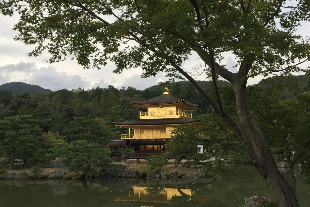 The gold-leafed Kinkaku-ji pavilion reflected in its garden pond