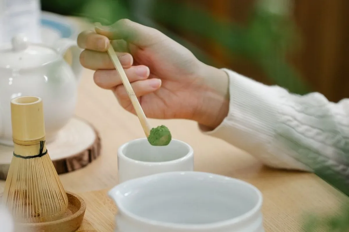 A traditional matcha tea ceremony set being prepared on tatami mats