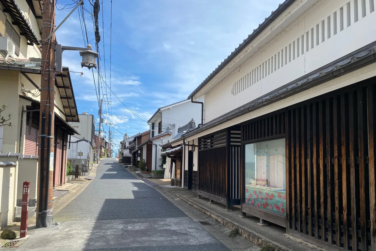 A traditional wooden machiya-lined street in Gion, Kyoto, at dusk