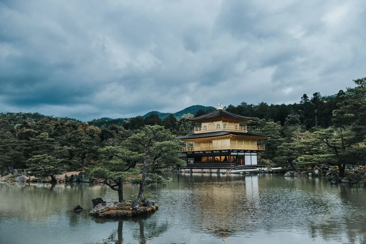 The gold-leafed Kinkaku-ji pavilion reflected in its garden pond